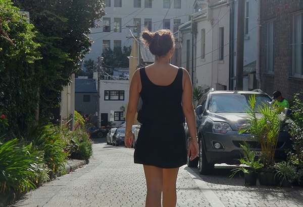 Image of a woman walking forward in a street
