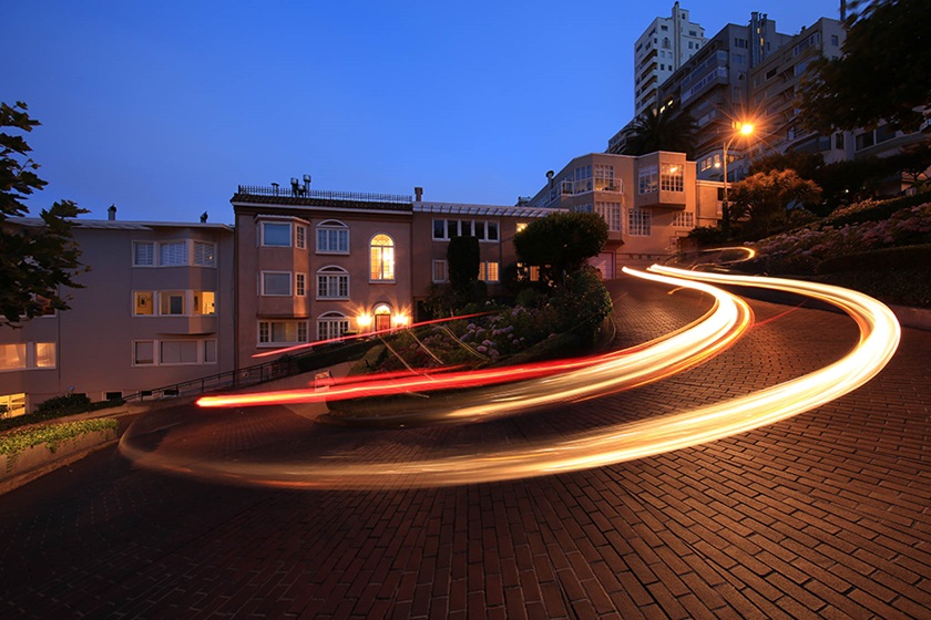 Image of a light trail left by a car on a winding road at night taken with the Canon EF 11-24mm f4L USM wide zoom lens