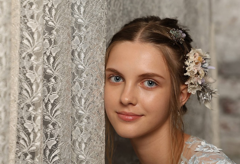 Portrait image of a model with flowers on hair taken using the EOS R6 Mark II mirrorless camera