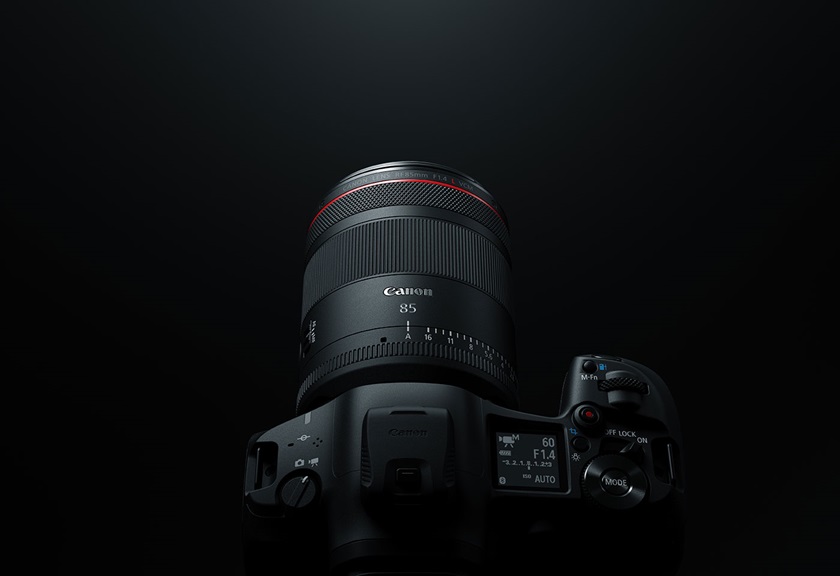 Image of a Canon camera with the RF 85mm f/1.4L VCM lens mounted on a black background