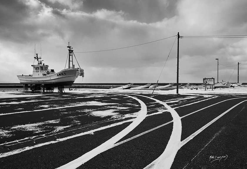 Black and white image of a boat on land by Canon Master Mike Langford