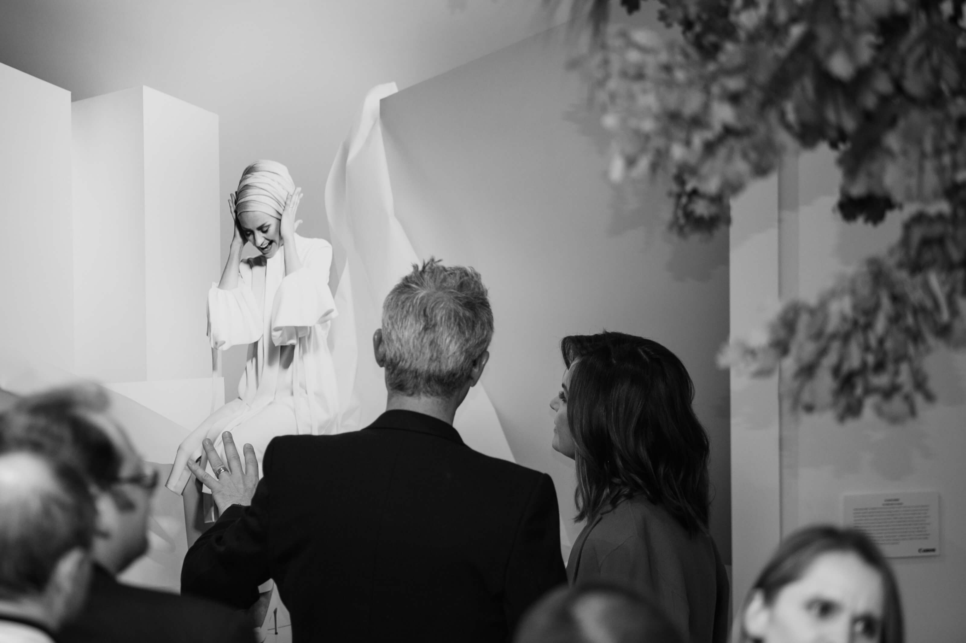 Black and white photo of Daniel Linnet and Lisa Wilkinson with model in background